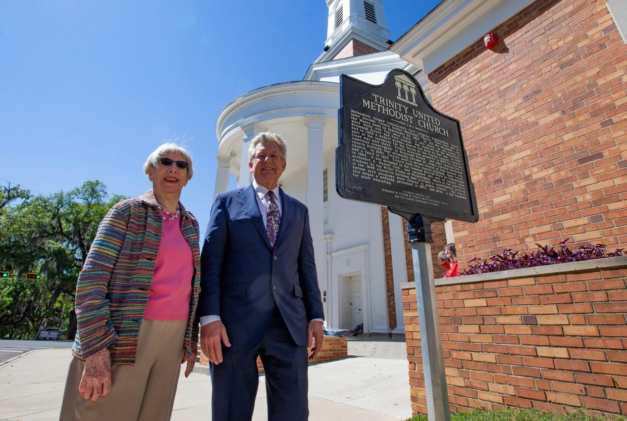 Rhonda Work, chair of the Trinity United Methodist Church historical society, left, and Pastor Watne Wiatt stand with the newly installed historical marker outside the church on Thursday, April 1, 2021. 