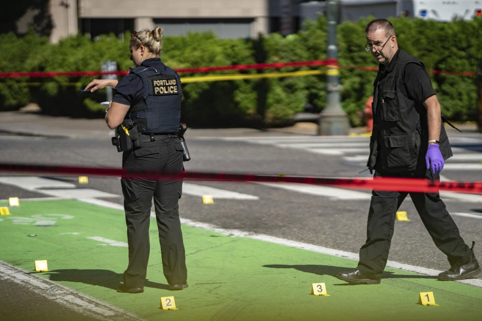Police investigate an overnight shooting Saturday, July 17, 2021 in Portland, Ore. Police said one person died and at least six people were injured in an early morning shooting Saturday in Portland, Oregon. (Mark Graves/The Oregonian via AP)