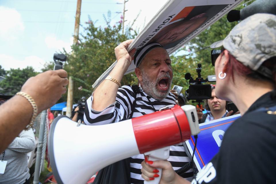 Domenic Santana yells at another protestor at Fulton County Jail intake center in Atlanta, Ga. on Aug 24, 2023. A grand jury in Fulton County, Georgia indicted former president Donald Trump and 18 other defendants with 41 charges related to tampering with the 2020 election. All defendants have been ordered to turn themselves in by August 25.