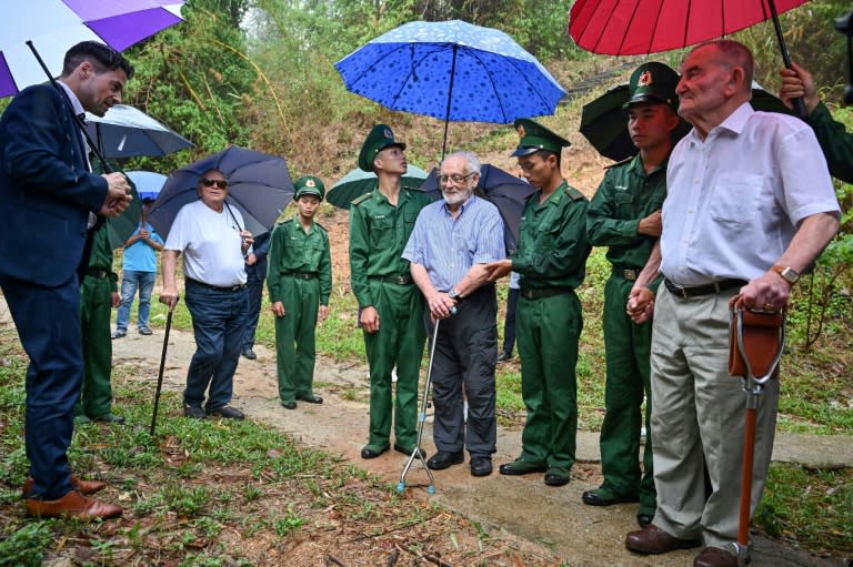French Dien Bien Phu veterans Jean-Yves Guinard (R), Andre Mayer (C) and William Schilardi (2L) visit the former battleground with the help of Vietnamese soldiers (Nhac NGUYEN)