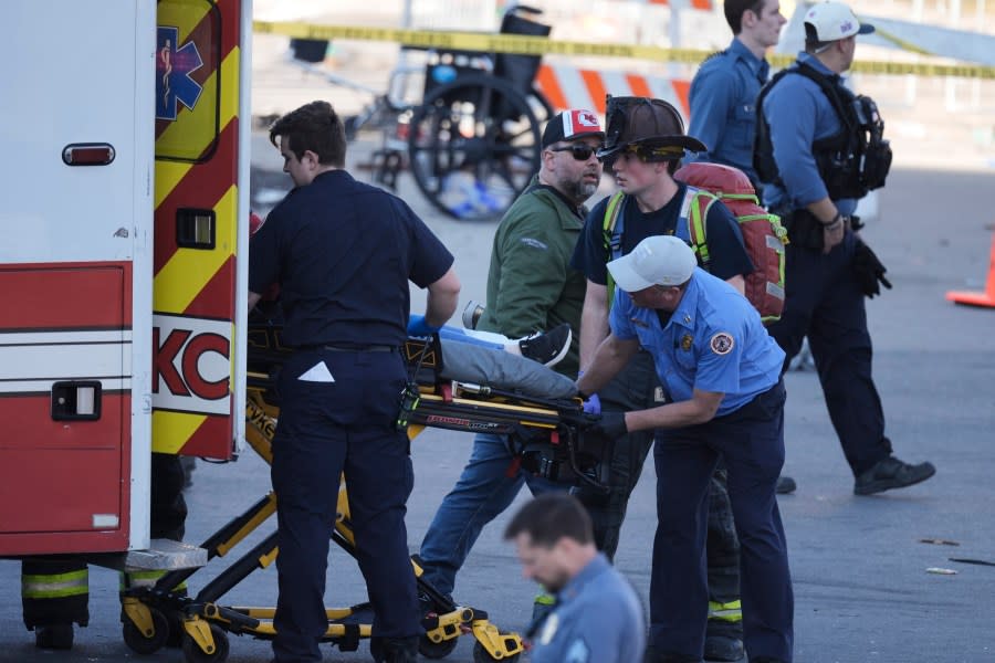 A person is taken to an ambulance after an incident following the Kansas City Chiefs victory parade in Kansas City, Mo., Wednesday, Feb. 14, 2024. The Chiefs defeated the San Francisco 49ers Sunday in the NFL Super Bowl 58 football game. (AP Photo/Charlie Riedel)