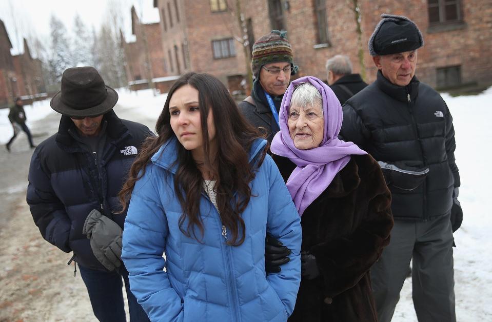 Rose Schindler, 85, a survivor of the Auschwitz-Birkenau concentration camp, walks through the camp with her granddaughter, husband and sons. Schindler arrived at Auschwitz as a 14-year-old Jewish girl from Czechoslovakia in 1944, and spent three months there, during which time her mother, father and sisters were killed. She met her husband, Max, after the war as refugees in Great Britain, where they married. 