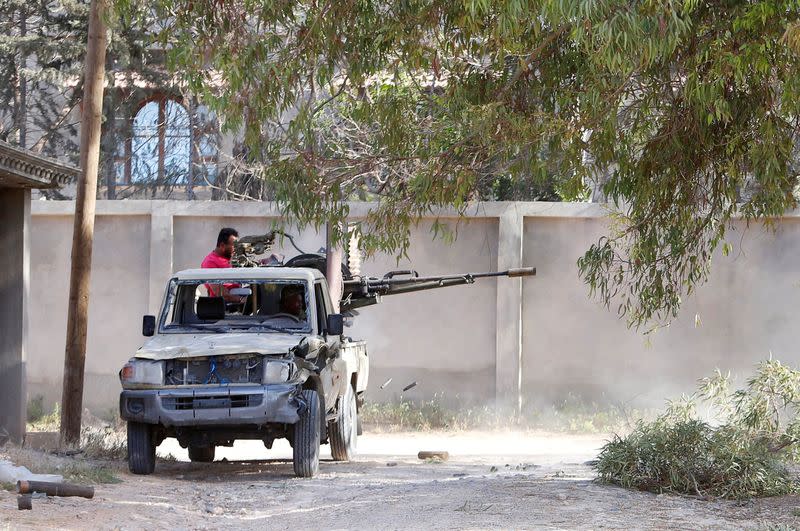 FILE PHOTO: Members of the Libyan internationally recognised government forces fire during a fight with Eastern forces in Ain Zara, Tripoli