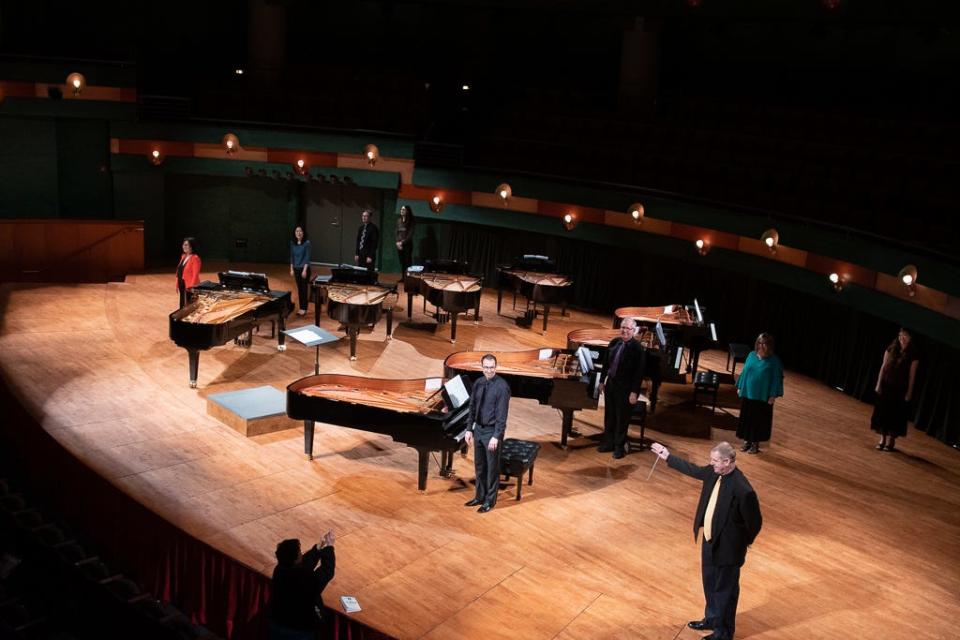 Brian Shelton, music professor and conductor at Texas A&M University-Corpus Christi, bottom right, stands onstage with eight pianists during a concert at Piano Celebration Week on the campus in 2019.