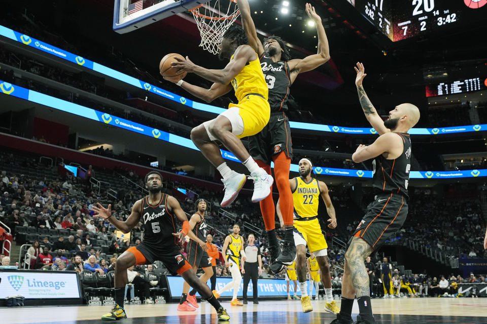 Indiana Pacers forward Aaron Nesmith (23) attempts a layup as Detroit Pistons center James Wiseman (13) defends during the first half of an NBA basketball game, Wednesday, March 20, 2024, in Detroit. (AP Photo/Carlos Osorio)