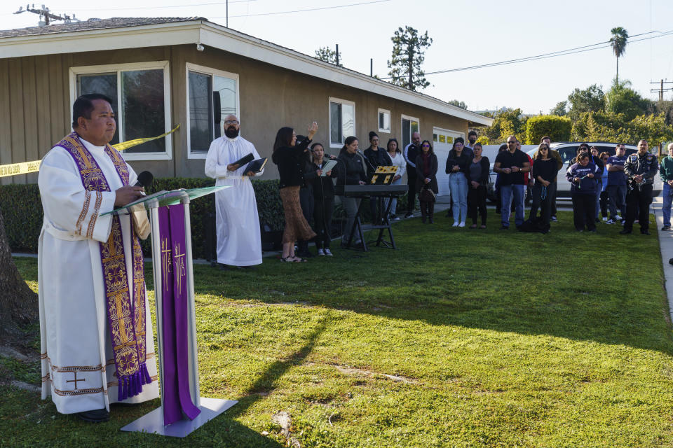 The Rev. Albert Avenido, left, and sacristan Hector Ibarra lead members of Sacred Heart Catholic Church in Covina, Calif., on a prayer vigil for Bishop David O'Connell near his home in Hacienda Heights, Calif., Sunday, Feb. 19, 2023. Bishop David O'Connell, a Roman Catholic bishop in Southern California was shot and killed Saturday, Feb. 18, 2023, just blocks from a church, a slaying that's stunned the Los Angeles religious community, authorities said. Detectives are investigating the death of Bishop David O'Connell as a homicide, according to the Los Angeles County Sheriff's Department. (AP Photo/Damian Dovarganes)