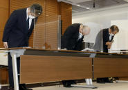 From left, Mitsui O.S.K. Lines, Ltd. Managing Executive Officer Masanori Kato, Mitsui O.S.K.Lines, Ltd. Representative Director Akihiko Ono, and Nagashiki Shipping CEO Kiyoaki Nagashiki bow during a press conference in Tokyo, Sunday, Aug. 9, 2020. The owners and operators of the grounded ship Wakashio on Sunday apologized for the accident that has led to tons of fuel leaking into Mauritius waters. (Kyodo News via AP)