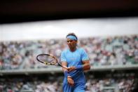 Rafael Nadal of Spain walks on the court during the men's singles match against Quentin Halys of France at the French Open tennis tournament at the Roland Garros stadium in Paris, France, May 26, 2015. REUTERS/Jean-Paul Pelissier