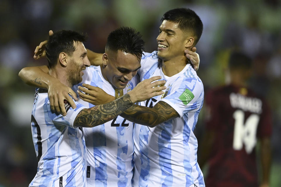 Argentina's Joaquin Correa, right, celebrates scoring his side's second goal against Venezuela with teammates Lautaro Martinez, center, and Argentina's Lionel Messi during a qualifying soccer match for the FIFA World Cup Qatar 2022 in Caracas, Venezuela, Thursday, Sept. 2, 2021. (Yuri Cortez, Pool via AP)