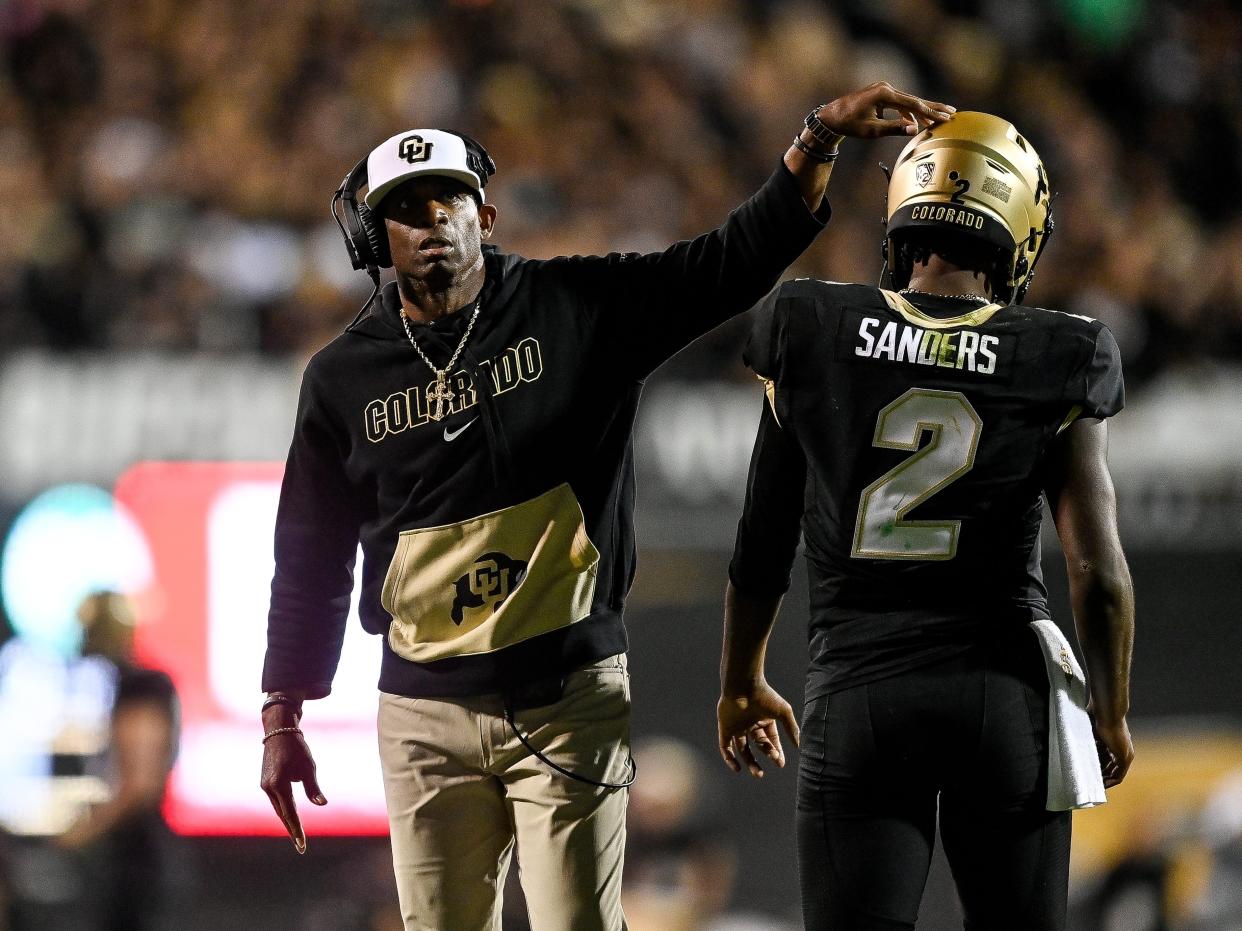 Head coach Deion Sanders of the Colorado Buffaloes celebrates with quarterback Shedeur Sanders #2 after a fourth quarter touchdown against the Colorado State Rams at Folsom Field on September 16, 2023 in Boulder, Colorado