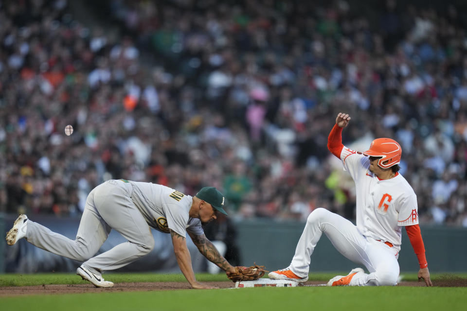 Oakland Athletics third baseman Jace Peterson, left, is unable to force out San Francisco Giants' Wilmer Flores, right, at third after a throwing error by pitcher Ken Waldichuk during the fifth inning of a baseball game Tuesday, July 25, 2023, in San Francisco. Brett Wisely reached first on the play. (AP Photo/Godofredo A. Vásquez)