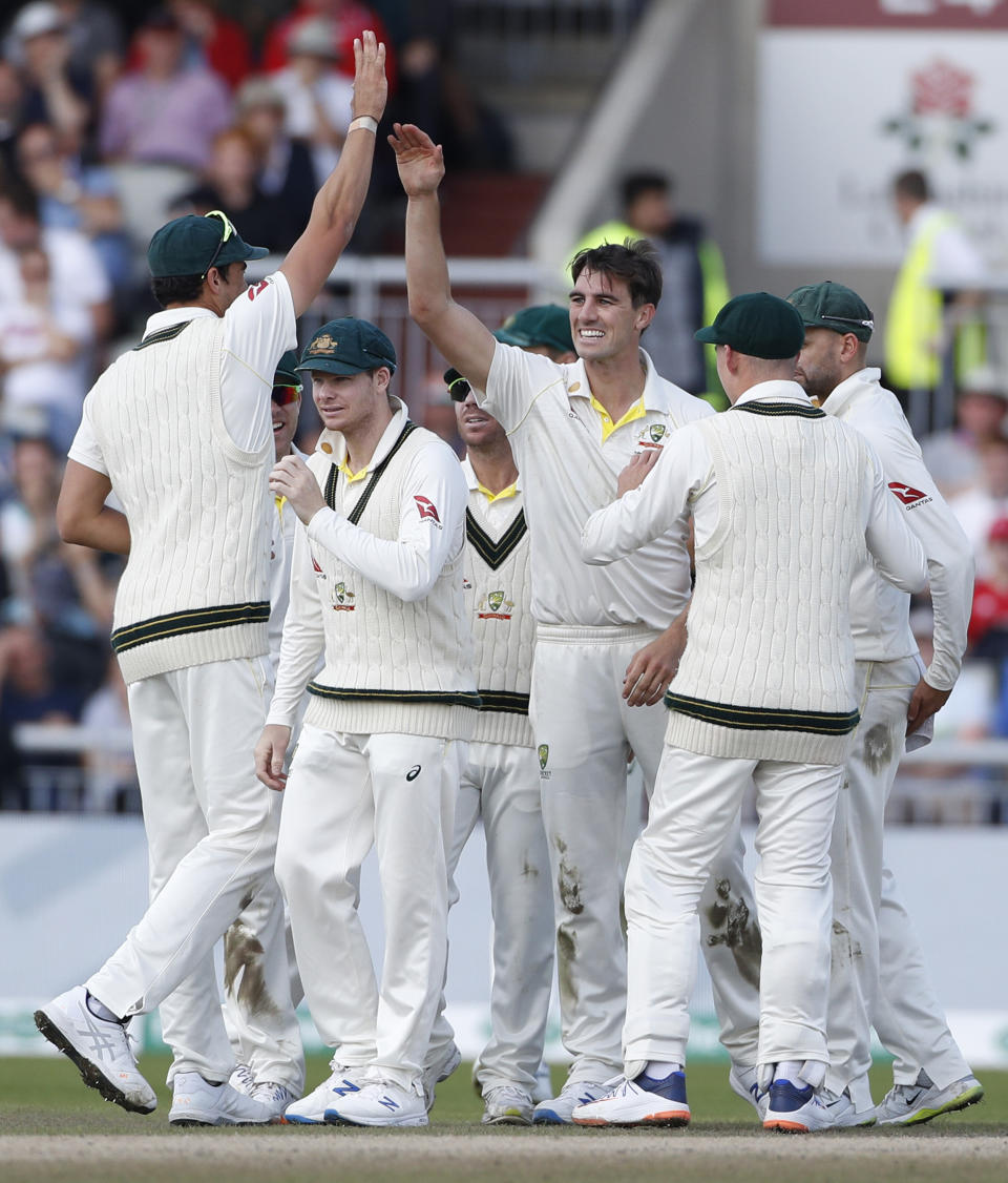 Australia's Pat Cummins, center, celebrates with teammates after dismissing England's Ben Stokes during day five of the fourth Ashes Test cricket match between England and Australia at Old Trafford in Manchester, England, Sunday Sept. 8, 2019. (AP Photo/Rui Vieira)