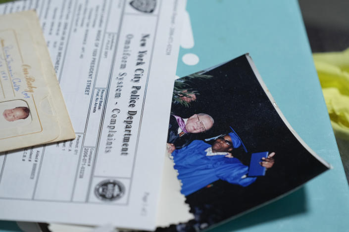 Debra Long looks through documents about the murder of her son, Randy Long, and photographs from his life, at her home in Poughkeepsie, N.Y., April 19, 2023. An AP examination of data from 23 states shows that Black people are disproportionately denied aid from programs that reimburse victims of violent crime. (AP Photo/Seth Wenig)