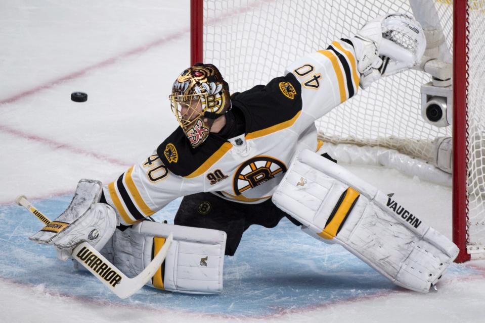 Boston Bruins goalie Tuukka Rask deflects a shot as they face the Montreal Canadiens during the first period in Game 4 in the second round of the NHL Stanley Cup playoffs Thursday, May 8, 2014, in Montreal. (AP Photo/The Canadian Press, Paul Chiasson)