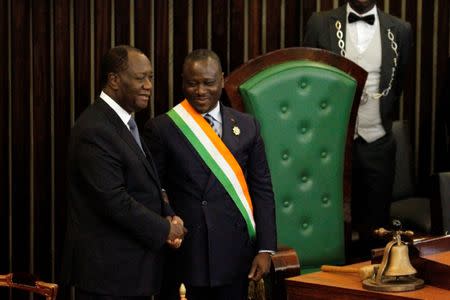 Ivory Coast's President Alassane Ouattara (L) shakes hands with Soro Guillaume, president of Ivory Coast's parliament after his speach at the Ivorian parliament in Abidjan October 5, 2016. REUTERS/Luc Gnago