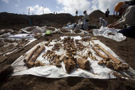 FILE - In this Dec. 14, 2010, file photo, the remains of Japanese soldiers, who died in the battle for Iwo Jima, lie on sheets as people exhume the remains of a mass grave site. Seventy-five years after the end of World War II, more than 1 million Japanese war dead are scattered throughout Asia, where the legacy of Japanese aggression still hampers recovery efforts. (AP Photo/David Guttenfelder, File)