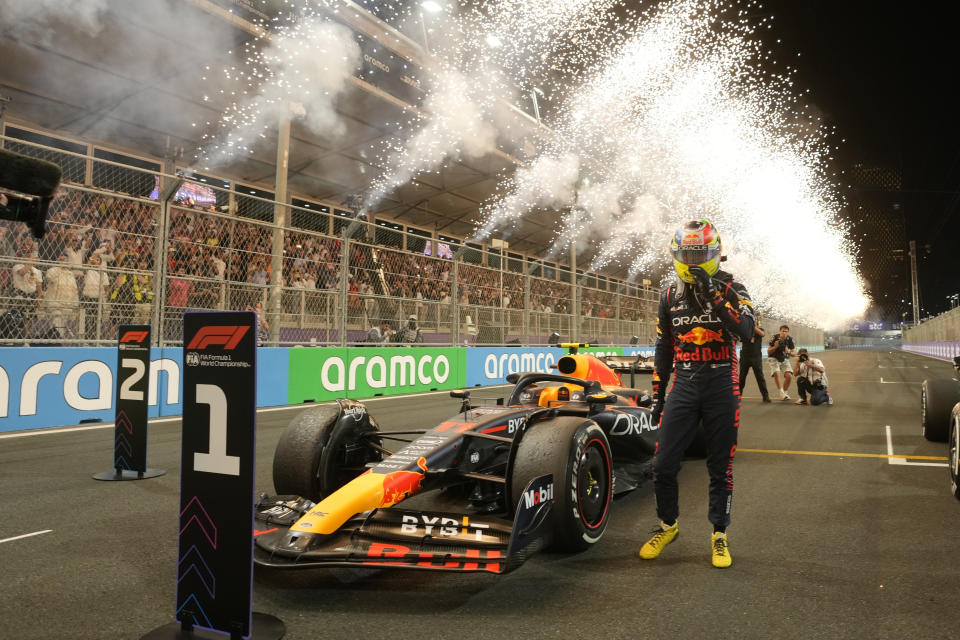 FILE - Red Bull driver Sergio Perez of Mexico stands next to his car after he won the Saudi Arabia Formula One Grand Prix at the Jeddah corniche circuit in Jeddah, Saudi Arabia, Sunday, March 19, 2023. The Saudis host a Formula One auto race that has come under scrutiny and had reportedly been considering buying the entire league from Liberty Media Corporation — a deal that didn't take off because Liberty didn't want to sell. (AP Photo/Luca Bruno, Pool)