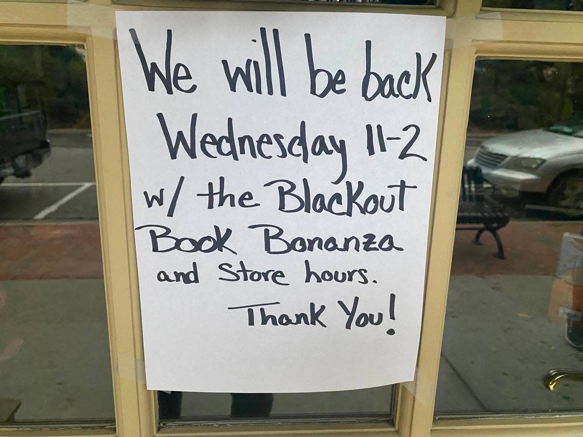 A sign taped outside the The Country Bookshop in Southern Pines, NC informs patrons of an upcoming Blackout sale.