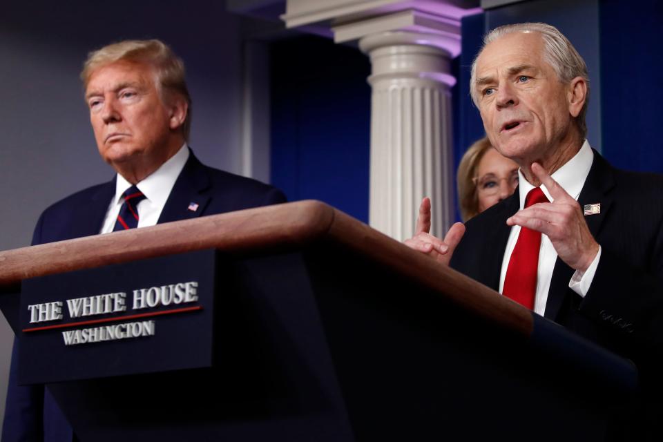 White House trade adviser Peter Navarro, who will now serve as national defense production act policy coordinator, speaks about the coronavirus in the James Brady Press Briefing Room, Friday, March 27, 2020, in Washington, as President Donald Trump listens. (AP Photo/Alex Brandon)