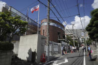 Media crews gather in front of the Poland's Embassy in Tokyo where Belarus sprinter Krystsina Tsimanouskaya is staying, Tuesday, Aug. 3, 2021. Tsimanouskaya lost a legal bid to be allowed to run in the Olympic 200 meters. It happened as she was seeking a humanitarian visa to leave the Tokyo Games safely. (AP Photo/Kantaro Komiya)