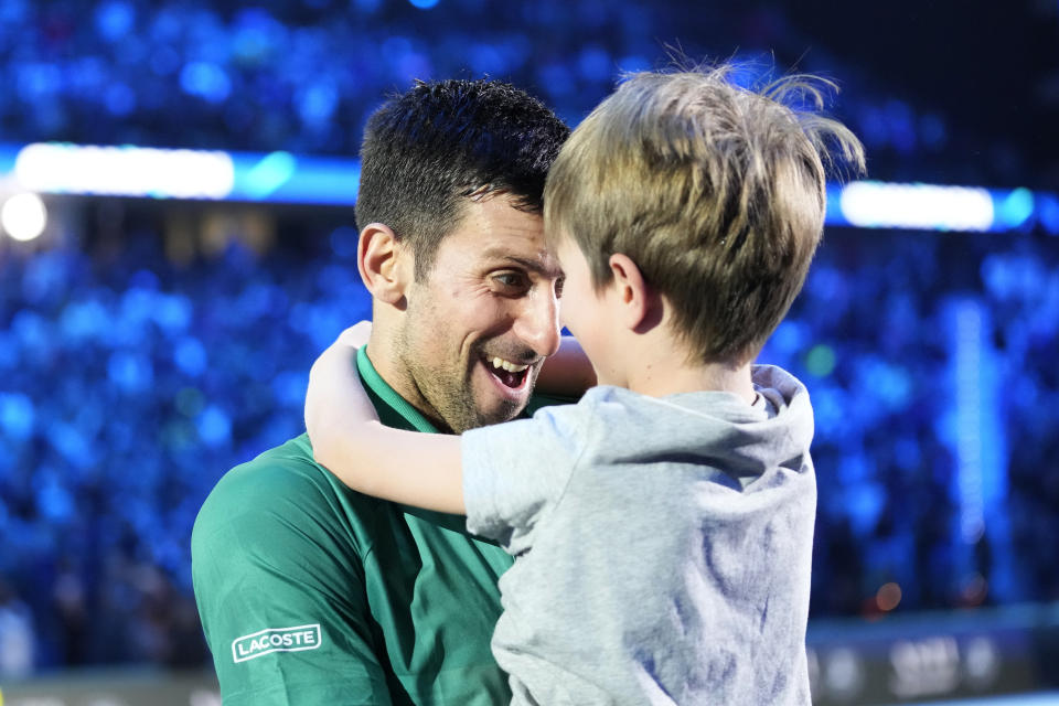 Serbia's Novak Djokovic celebrates with his son after defeating Norway's Casper Ruud 7-5, 6-3, in their singles final tennis match of the ATP World Tour Finals at the Pala Alpitour, in Turin, Italy, Sunday, Nov. 20, 2022. (AP Photo/Antonio Calanni)