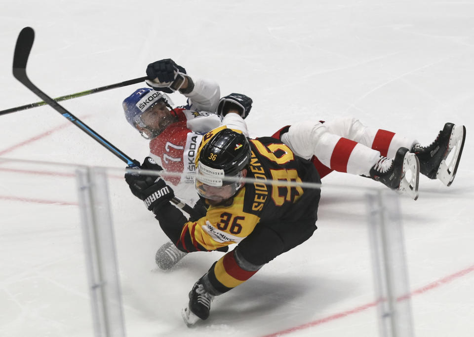 Czech Republic's Milan Gulas falls after challenging for the puck with Germany's Yannic Seidenberg during the Ice Hockey World Championships quarterfinal match between Germany and the Czech Republic at the Steel Arena in Bratislava, Slovakia, Thursday, May 23, 2019. (AP Photo/Ronald Zak)