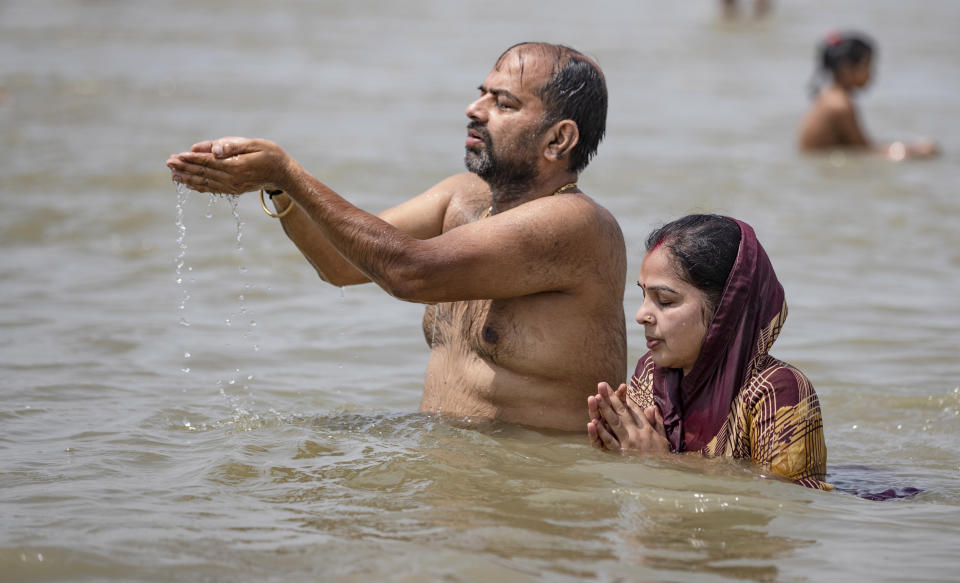 Hindu devotees offer prayers in the River Ganges, during the Ganga Dussehra festival, in Prayagraj, India, Monday, June 1, 2020. Hundreds of Hindu devotees made holy dips here Monday even though congregations at religious venues continue to remain barred during the nationwide coronavirus lockdown. (AP Photo/Rajesh Kumar Singh)