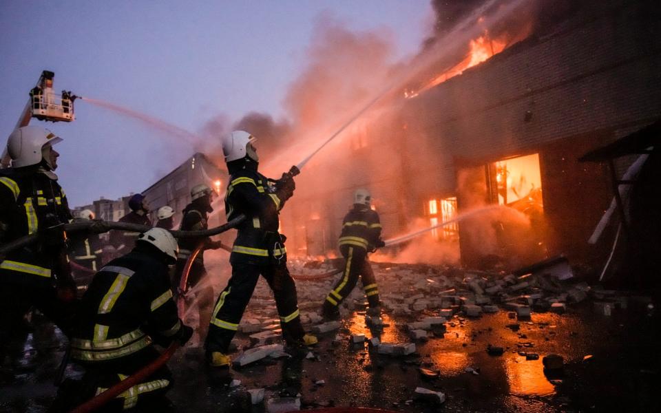 Ukrainian firefighters extinguish a blaze at a warehouse in Kyiv after it was shelled by Russians - Vadim Ghirda /AP
