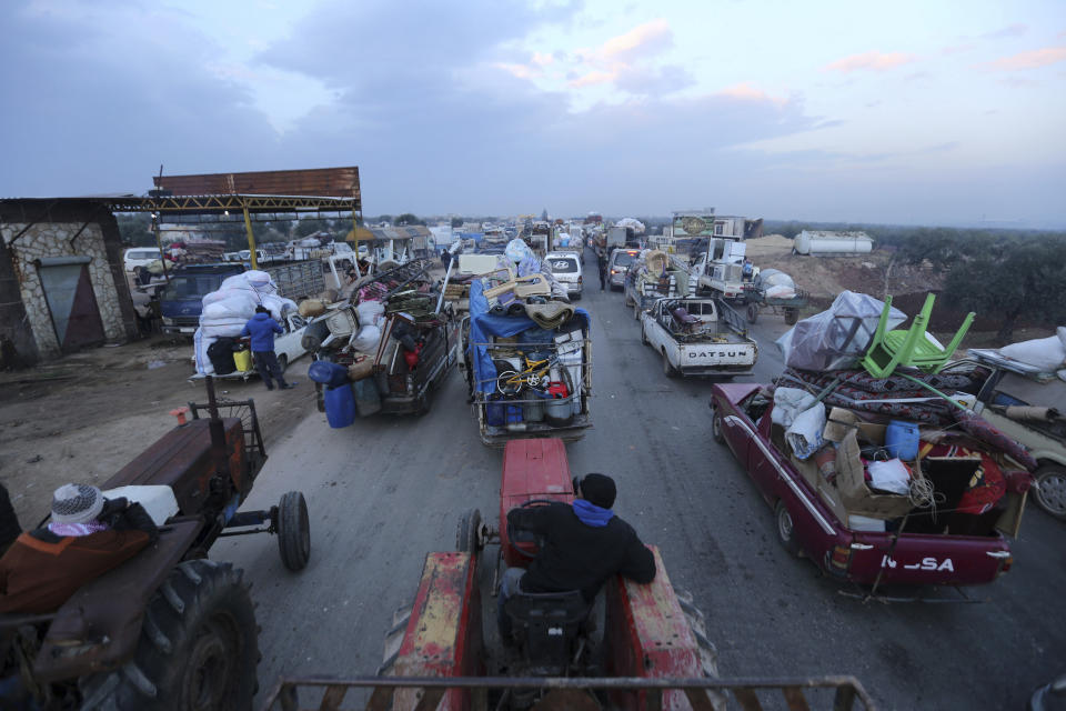 Truckloads of civilians flee a Syrian military offensive in Idlib province on the main road near Hazano, Syria, Tuesday, Dec. 24, 2019. Syrian forces launched a wide ground offensive last week into the northwestern province of Idlib, which is dominated by al-Qaida-linked militants. The United Nations estimates that some 60,000 people have fled from the area, heading south, after the bombings intensified earlier this month. (AP Photo/Ghaith al-Sayed)