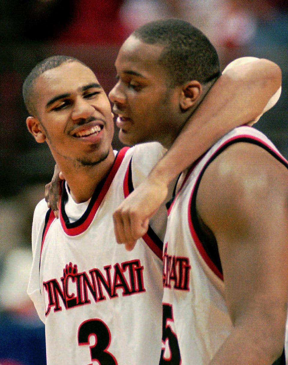 3/17/96- uc's damon flint (left) hugs danny fortson as the two walk off the court following their second round ncaa victory over temple in orlando.