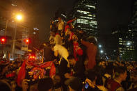 Toronto Raptors fans celebrate atop a vehicle following the Raptors' defeat of the Golden State Warriors in game 6 of the NBA Finals to win the NBA Championship, in Toronto, Friday, June 14, 2019. (Chris Young/The Canadian Press via AP)