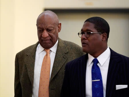 Actor and comedian Bill Cosby walks with his publicist Andrew Wyatt, during his sexual assault retrial at the Montgomery County Courthouse in Norristown, Pennsylvania, U.S. April 23, 2018. REUTERS/Jessica Kourkounis