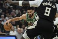 Boston Celtics' Jayson Tatum tries to get past Milwaukee Bucks' Bobby Portis during the first half of an NBA basketball game Tuesday, April 9, 2024, in Milwaukee. (AP Photo/Morry Gash)