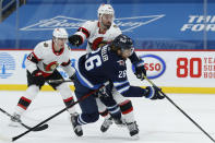 Winnipeg Jets' Blake Wheeler (26) attempts to get past Ottawa Senators' Erik Gudbranson (44) during the second period of an NHL hockey game Saturday, Jan. 23, 2021, in Winnipeg, Manitoba. (John Woods/The Canadian Press via AP)