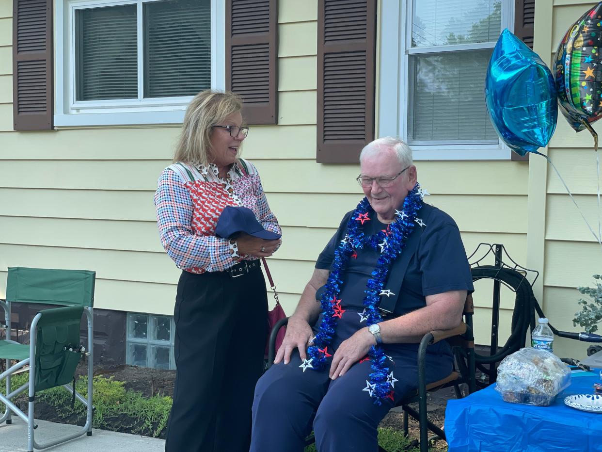 Marysville Mayor Kathy Hayman giving Marysville resident Larry Morrish a 100th anniversary hat at his birthday party on June 17, 2024. Morrish turns 86 on June 21.