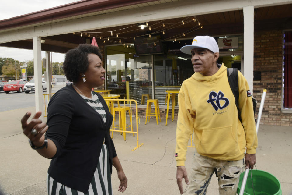 Jennifer-Ruth Green, the Republican candidate for Indiana's 1st Congressional District and an U.S. Air Force veteran left, talks with window washer James Brown, right before a roundtable meeting Thursday, Oct. 20, 2022, in Gary, Ind. (AP Photo/Paul Beaty)