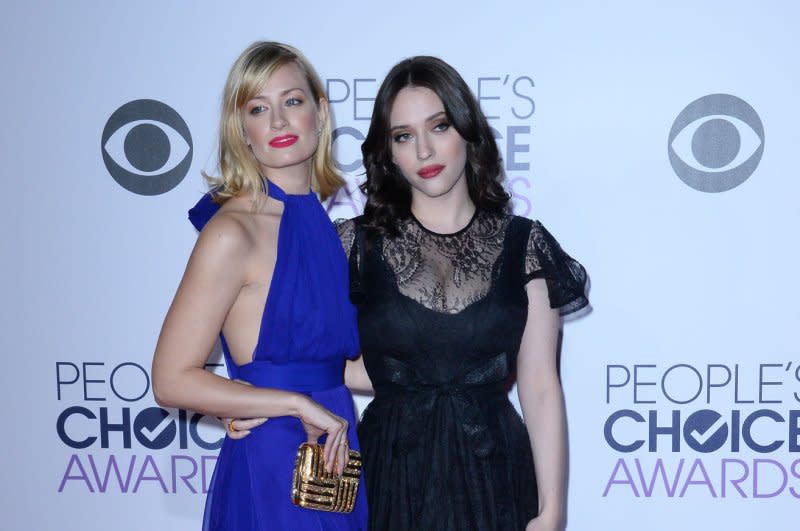 Kat Dennings (R) and Beth Behrs attend the People's Choice Awards in 2015. File Photo by Jim Ruymen/UPI