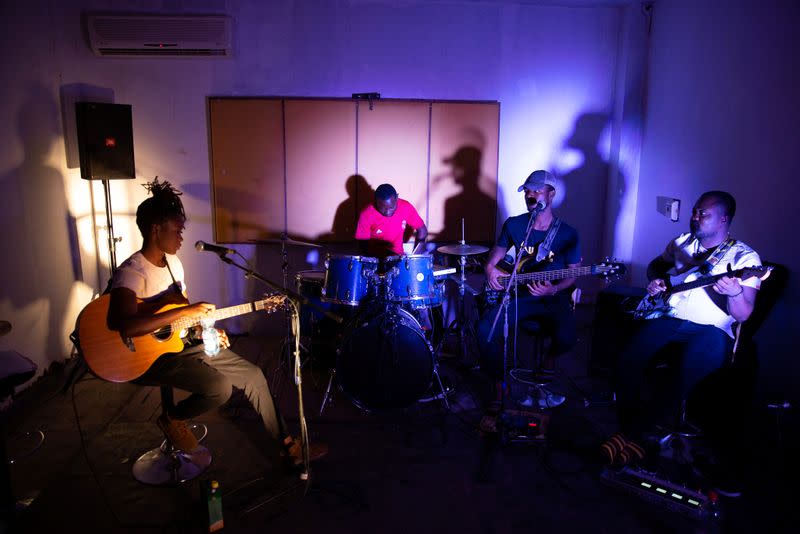 Congolese singer Celine Banza strums a guitar at a band practice studio in the French Institute in central Kinshasa