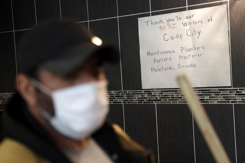 A sign thanking Co-op City employees is displayed in the lobby of a building in Co-op City in the Bronx borough of New York, Wednesday, May 13, 2020. Within the Bronx, almost no place has been hit as hard as Co-op City. Data released by city health officials Monday revealed that the virus has killed at least 155 people living in the zip code that covers the complex. That’s roughly 1 of every 282 residents. (AP Photo/Seth Wenig)