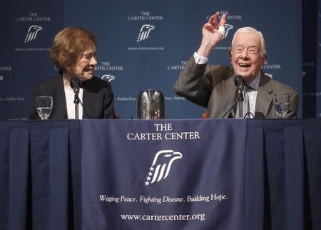 Former U.S. President Jimmy Carter gestures as he answers questions during "A Conversation with the Carters," as wife Rosalynn Carter looks on during the annual public event at The Carter Center in Atlanta, Georgia September 15, 2015. REUTERS/Tami Chappell