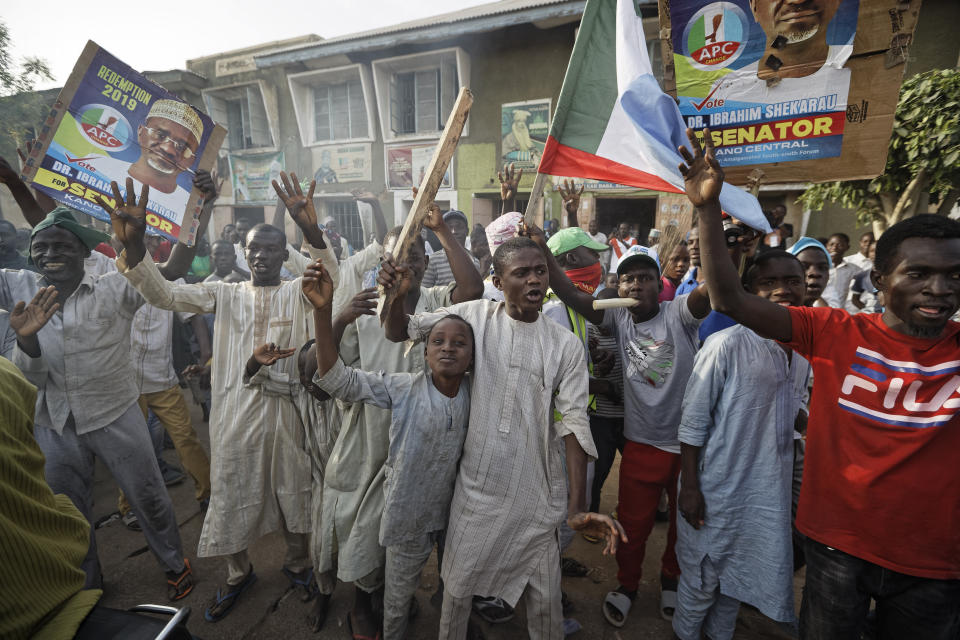 Supporters of President Muhammadu Buhari celebrate the announcement of results favoring his All Progressives Congress (APC) party in their state, anticipating victory, in Kano, northern Nigeria Monday, Feb. 25, 2019. Nigeria's electoral commission on Monday began announcing official results from the country's 36 states as President Muhammadu Buhari seeks a second term. (AP Photo/Ben Curtis)