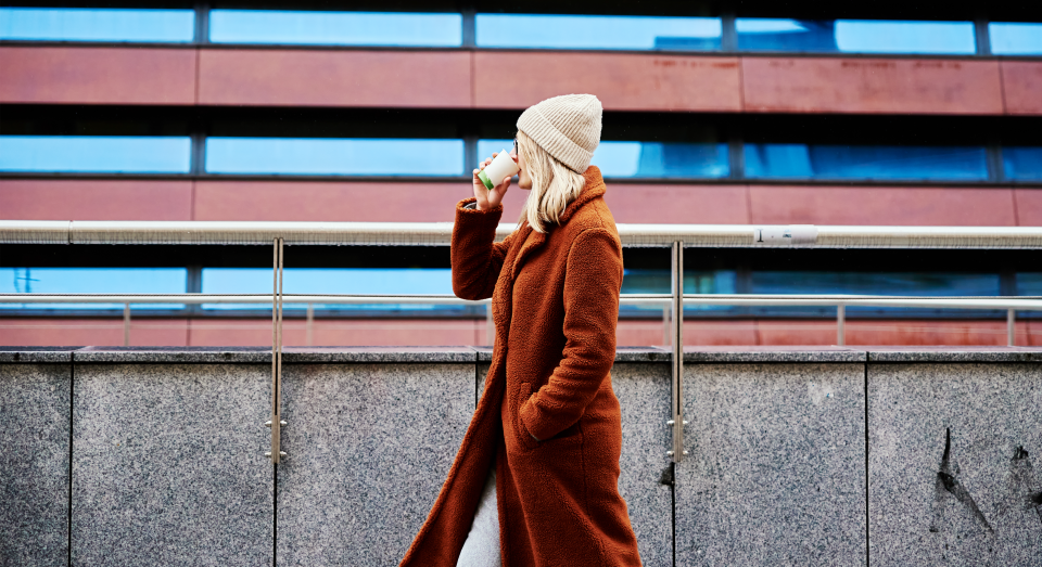 Woman walking outside with coffee