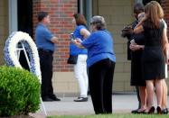 Mourners stand outside the art center before a funeral service for Otto Warmbier at Wyoming High School in Wyoming, Ohio. REUTERS/John Sommers II