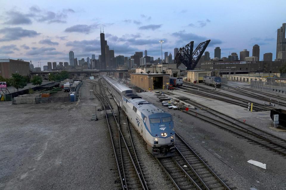 FILE - An Amtrak passenger train departs Chicago in the early evening headed south Wednesday, Sept. 14, 2022, in Chicago. President Joe Biden said Thursday, Sept. 15, 2022, that a tentative railway labor agreement has been reached, averting a potentially devastating strike before the pivotal midterm elections. (AP Photo/Charles Rex Arbogast, File)