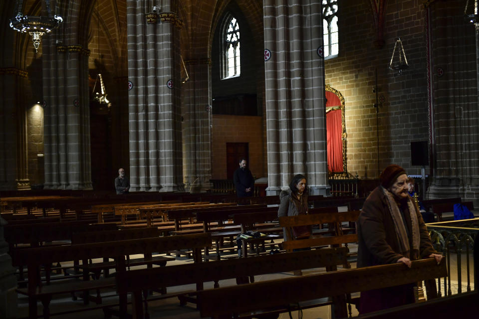 A group of select devotees take part during the Holy Wednesday Mass at Santa Maria Cathedral, in Pamplona, northern Spain, Wednesday, April 8, 2020. COVID-19 causes mild or moderate symptoms for most people, but for some, especially older adults and people with existing health problems, it can cause more severe illness or death. (AP Photo/Alvaro Barrientos)