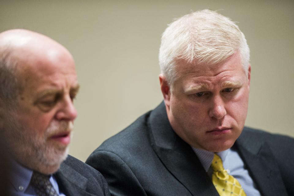 FILE - In this Jan. 10, 2018, file photo, Defendant Stephen Busch, right, listens at Flint District Court in Flint, Mich. Michael Prysby and Busch, two Michigan environmental regulators implicated in the Flint water scandal, have pleaded no contest to misdemeanors in exchange for more serious charges being dropped. (Jake May/The Flint Journal via AP, File)/
