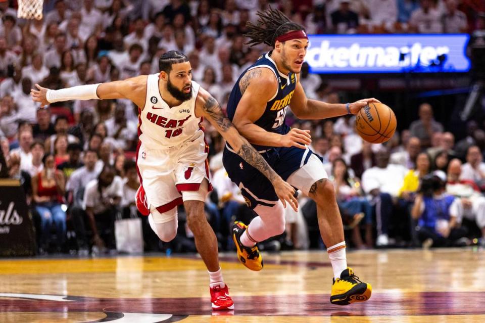 Miami Heat forward Caleb Martin (16) defends Denver Nuggets forward Aaron Gordon (50) as he drives down court during the first half of Game 4 of the NBA Finals at the Kaseya Center on Friday, June 9, 2023, in downtown Miami, Fla.