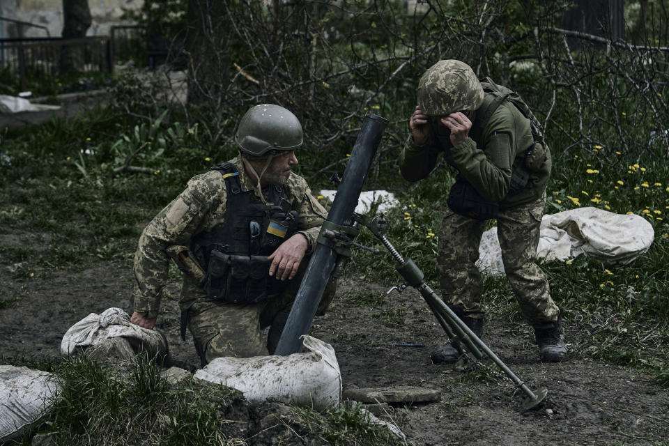 Ukrainian soldiers prepare to fire on the frontline near Avdiivka, an eastern city where fierce battles against Russian forces have been taking place, in the Donetsk region, Ukraine, Friday, April 28, 2023. (AP Photo/Libkos)