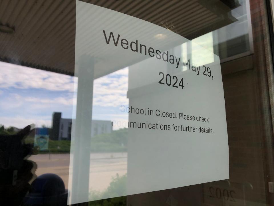 A sign posted to a window at St. Mary's High School on Wednesday after it was announced the school was closed for the day due to threatened violence. 