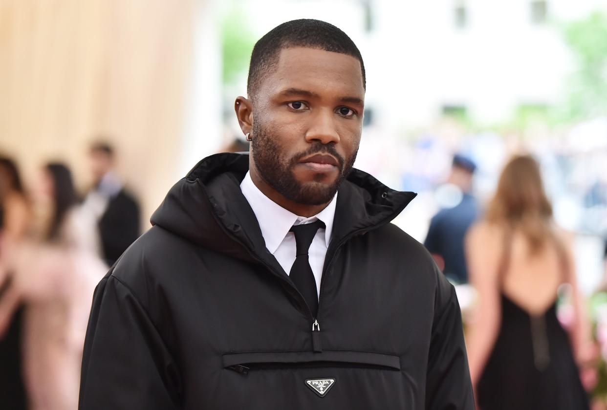Frank Ocean in a prada jacket, white shirt, and a black tie